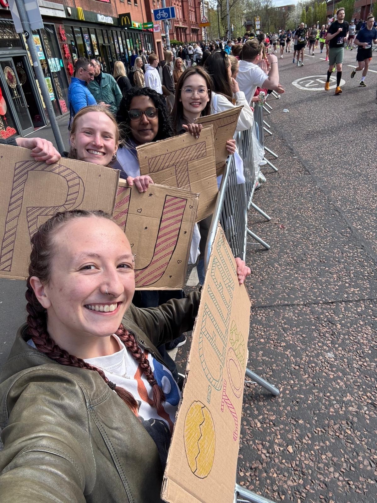 Lab team holding RUTH signs at the marathon